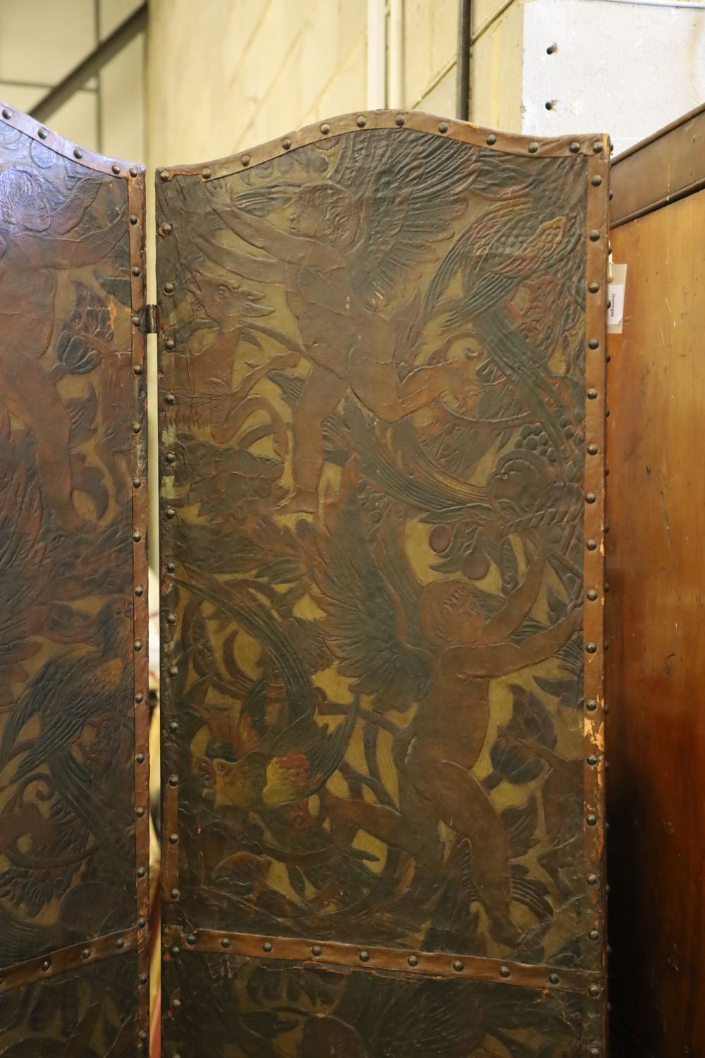 A Dutch leather four fold screen, c.1860, each panel 49cm x 203cm